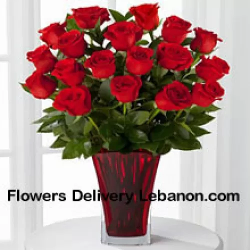 18 Red Roses With Seasonal Fillers In A Glass Vase Decorated With A Pink Bow