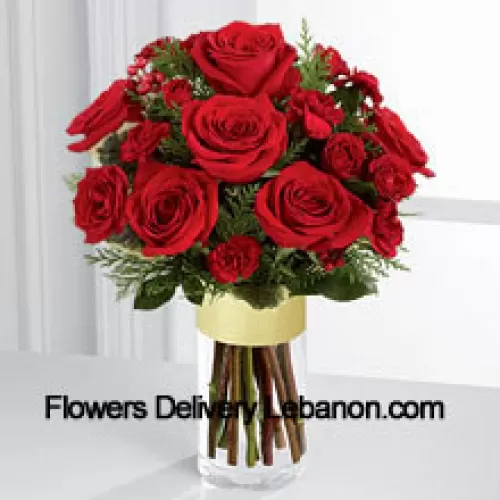 Send them the warmth and heartfelt sentiments expressed throughout the holiday season. Rich red roses and spray roses are offset by burgundy mini carnations, variegated holly stems and assorted holiday greens, beautifully arranged in a clear glass gold banded vase to bring your special recipient a merry moment they will treasure throughout the Christmas season. (Please Note That We Reserve The Right To Substitute Any Product With A Suitable Product Of Equal Value In Case Of Non-Availability Of A Certain Product)